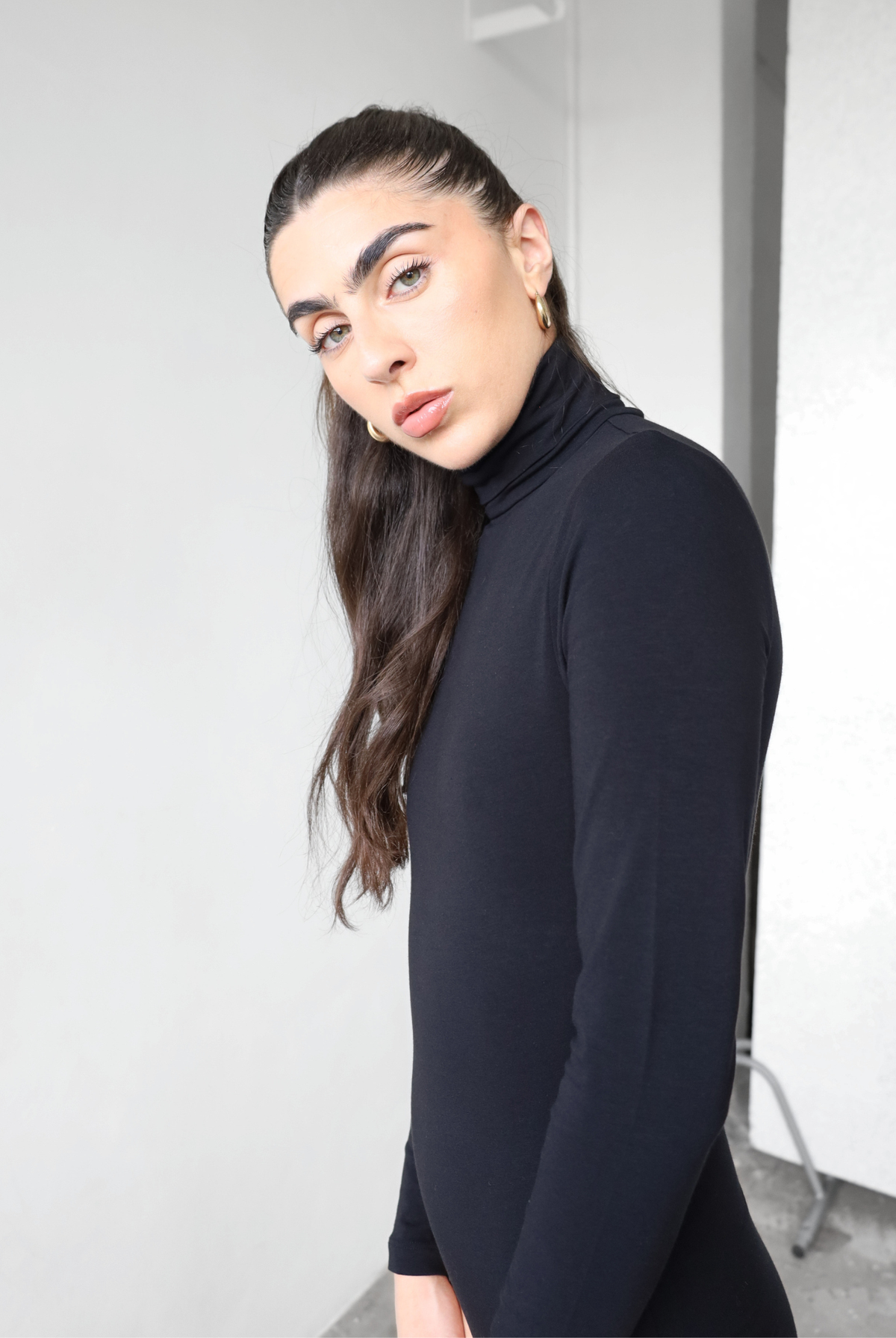 Organic cotton black roll neck long sleeve bodysuit, side