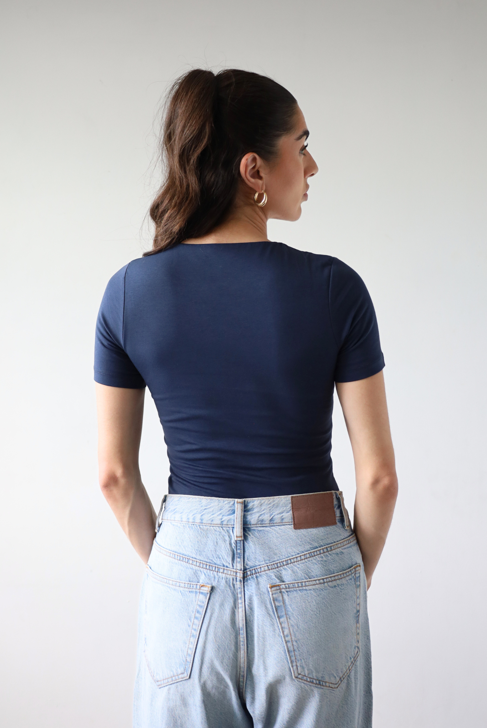 Organic cotton navy blue short sleeve t-shirt on model, back