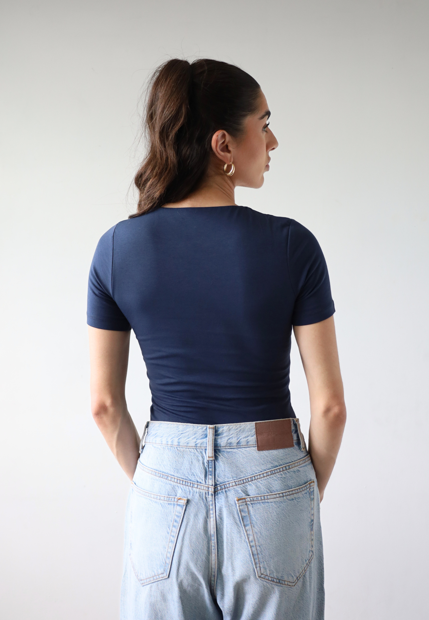 Organic cotton navy blue short sleeve t-shirt on model, back