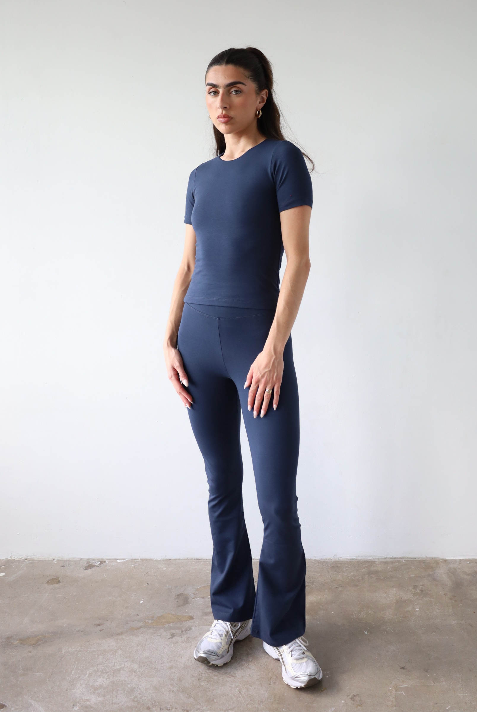 Organic cotton navy blue flared leggings on model, front