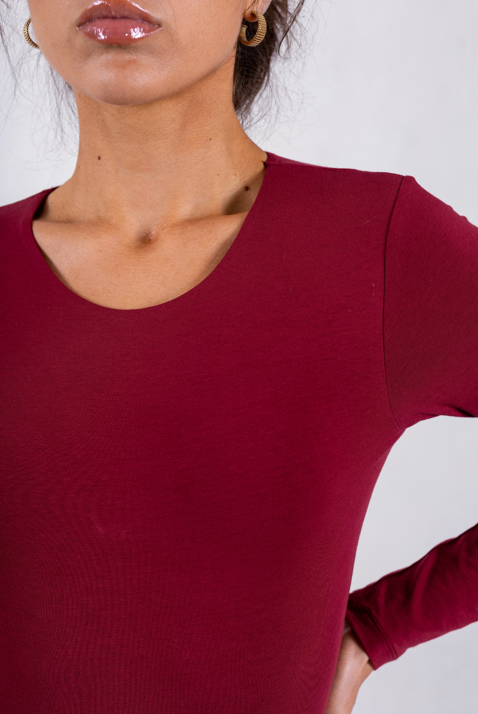 close up of red organic cotton long sleeve crew neck bodysuit