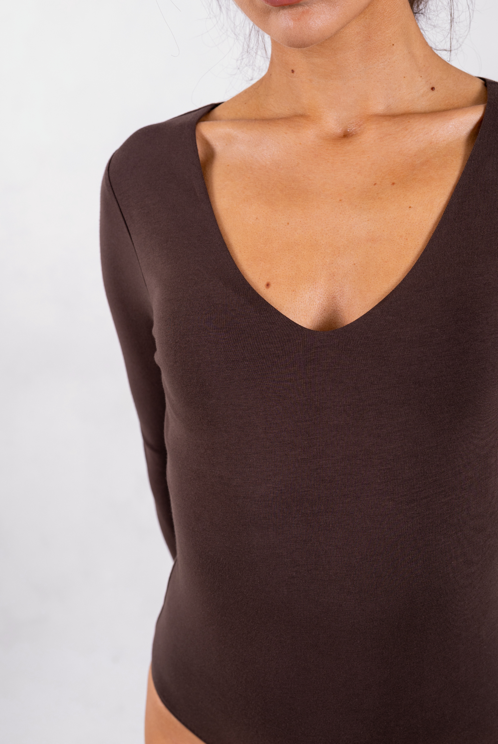 close up of brown organic cotton v-neck long sleeve bodysuit