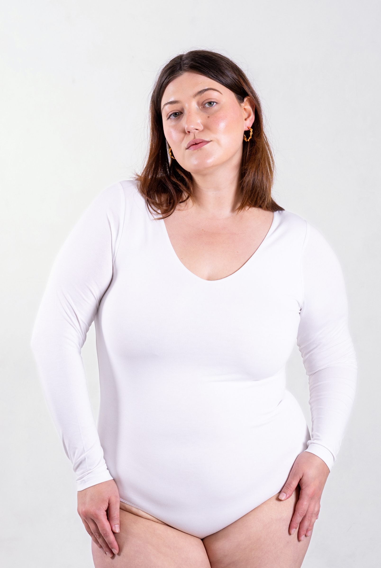 front of white organic cotton v-neck long sleeve bodysuit