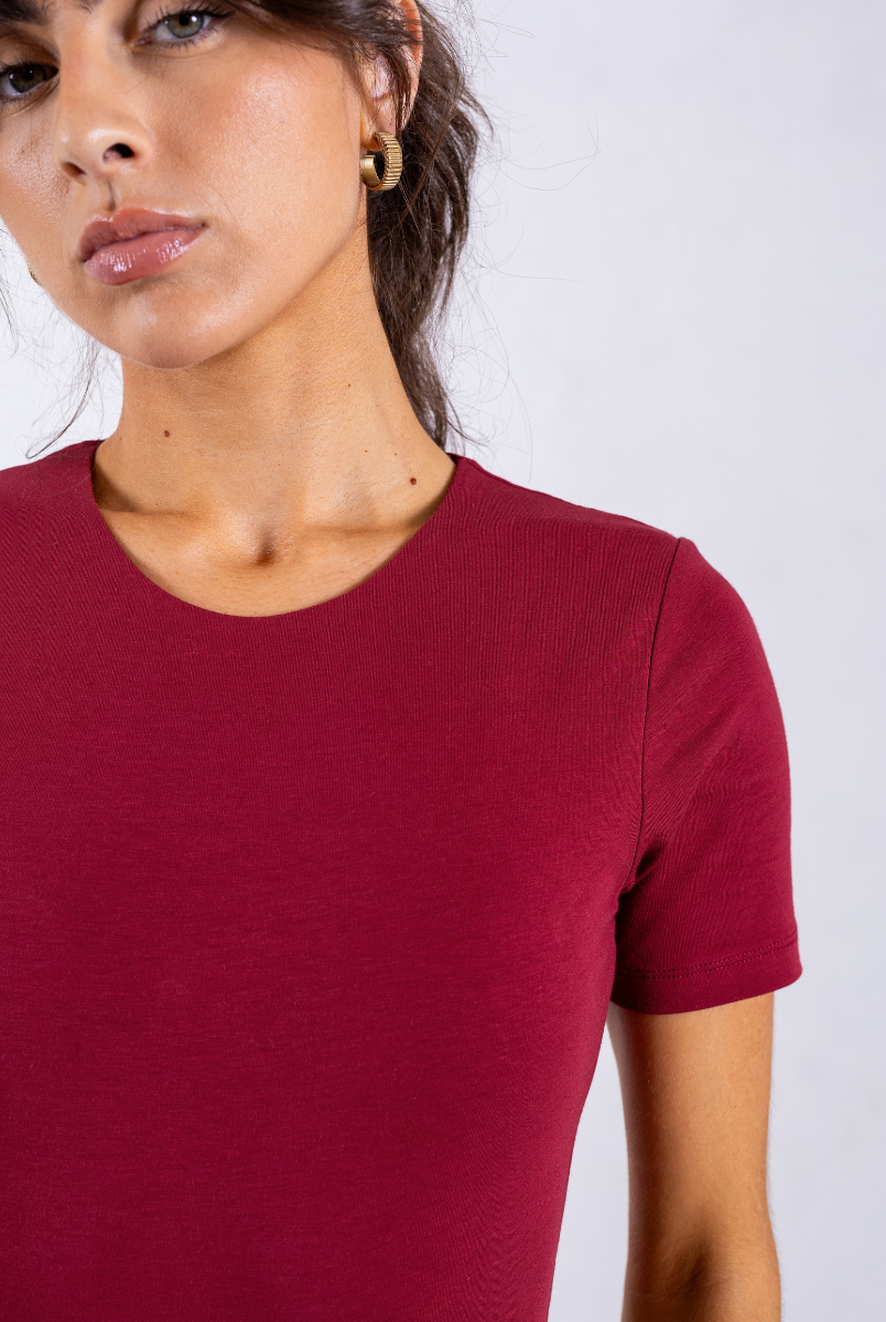 close up of red organic cotton short sleeve crew neck bodysuit