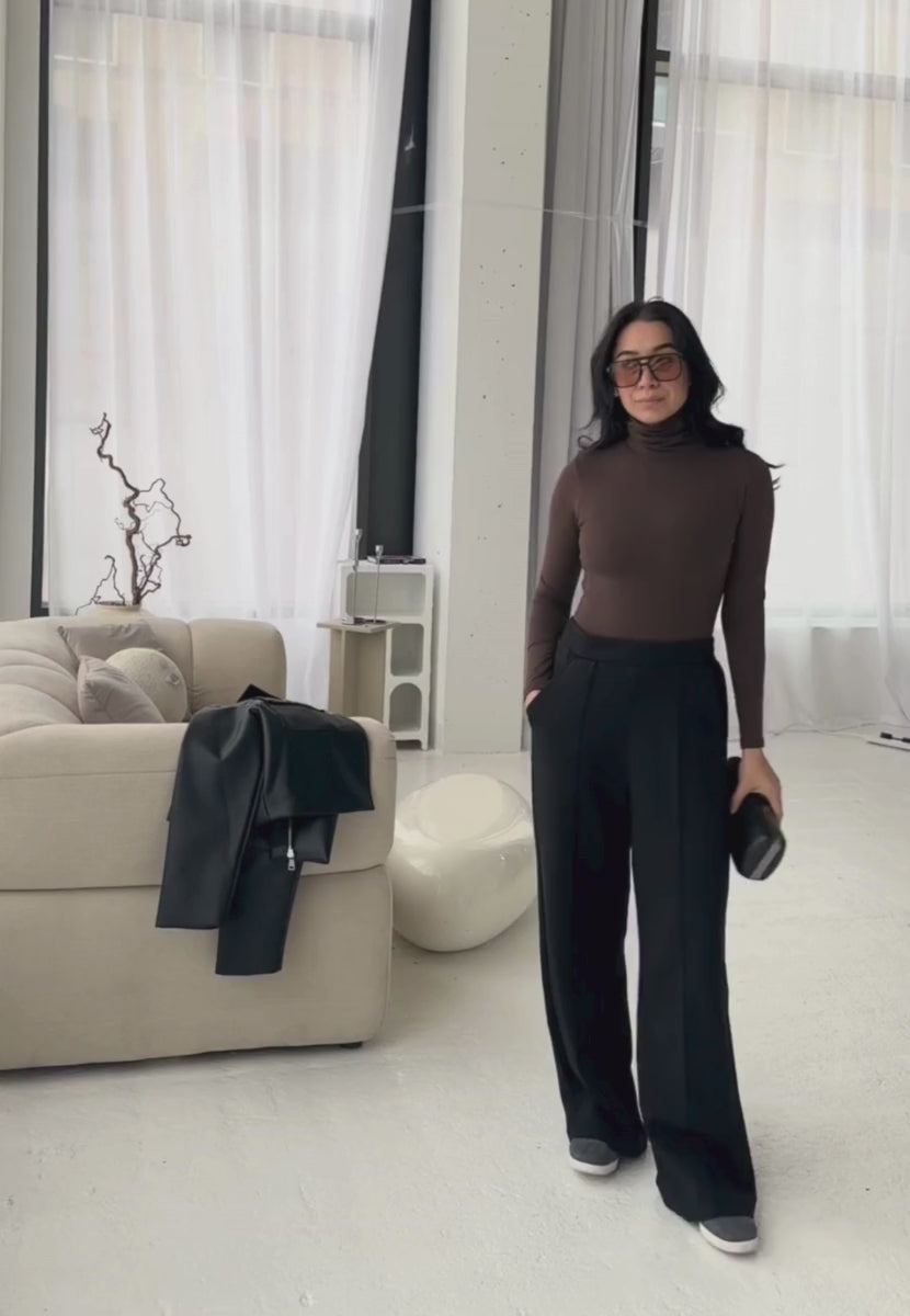 styling video of brown organic cotton roll neck long sleeve bodysuit