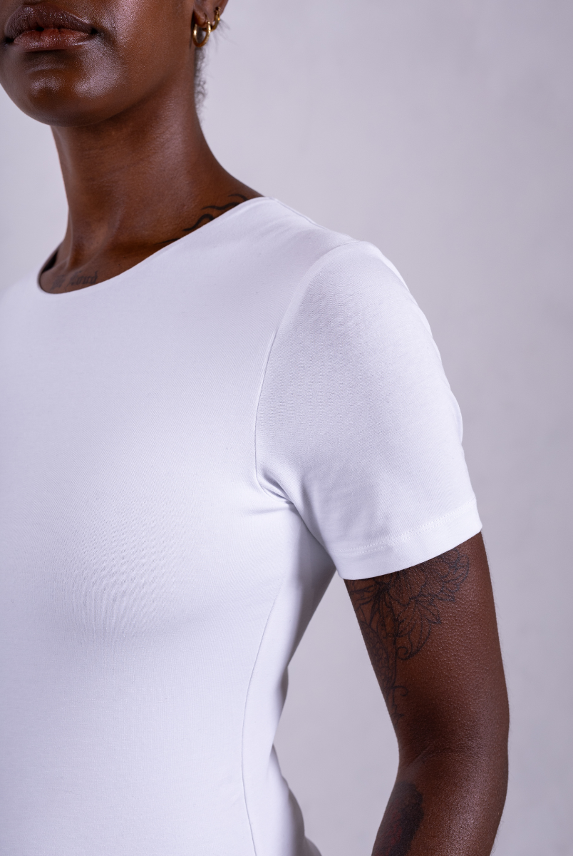 close up of organic cotton crew neck white short sleeve bodysuit