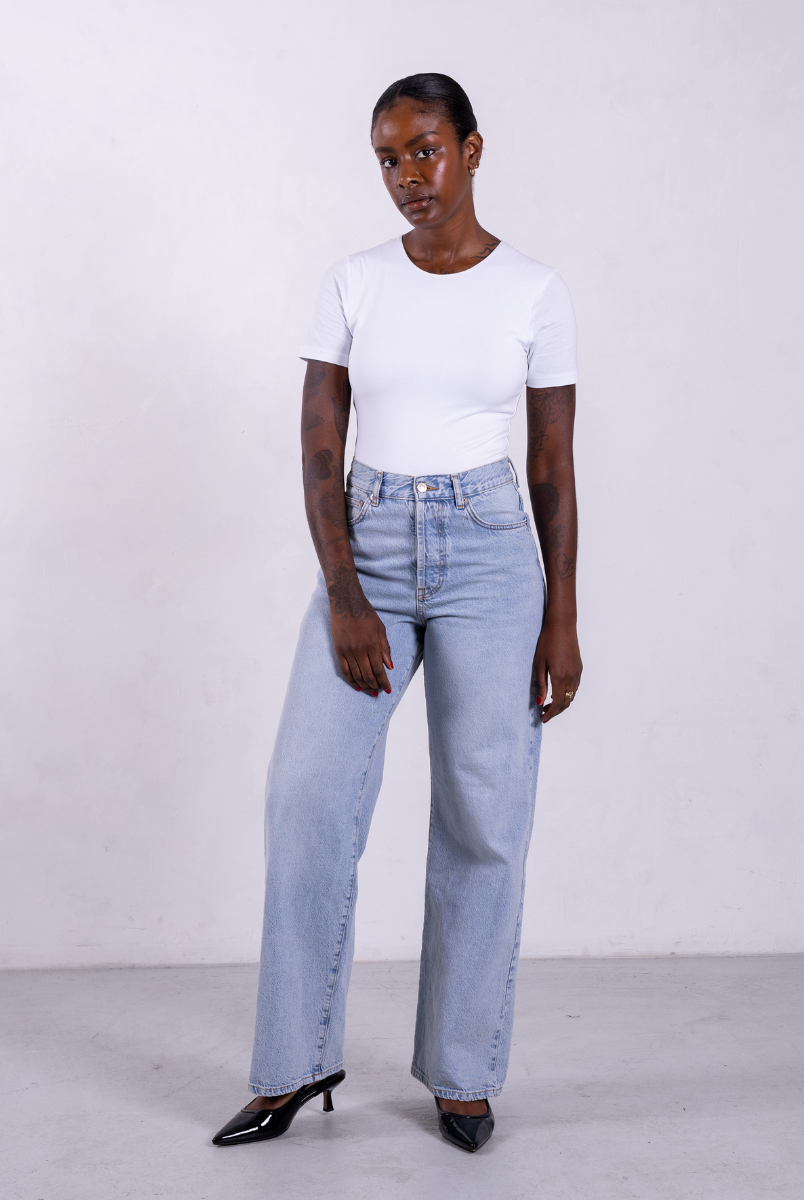 styled image of organic cotton crew neck white short sleeve bodysuit