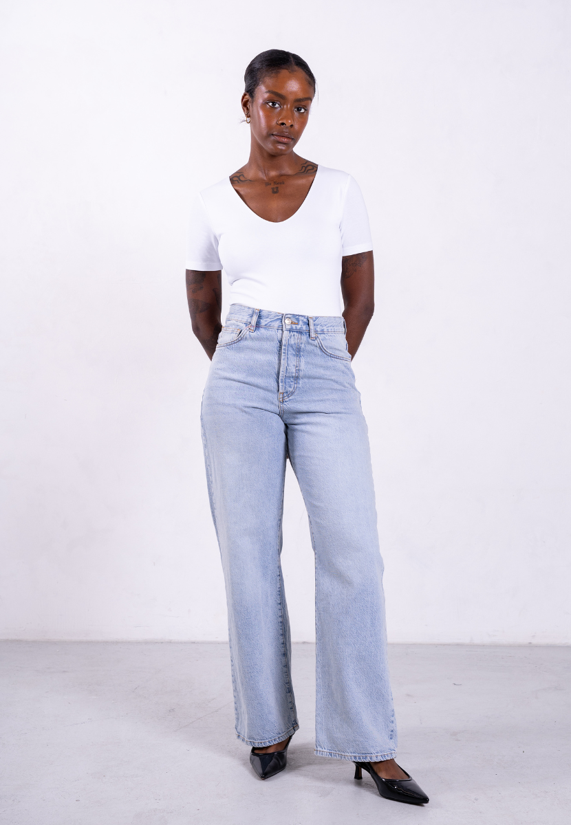 styled image of organic cotton v-neck short sleeve v-neck white bodysuit