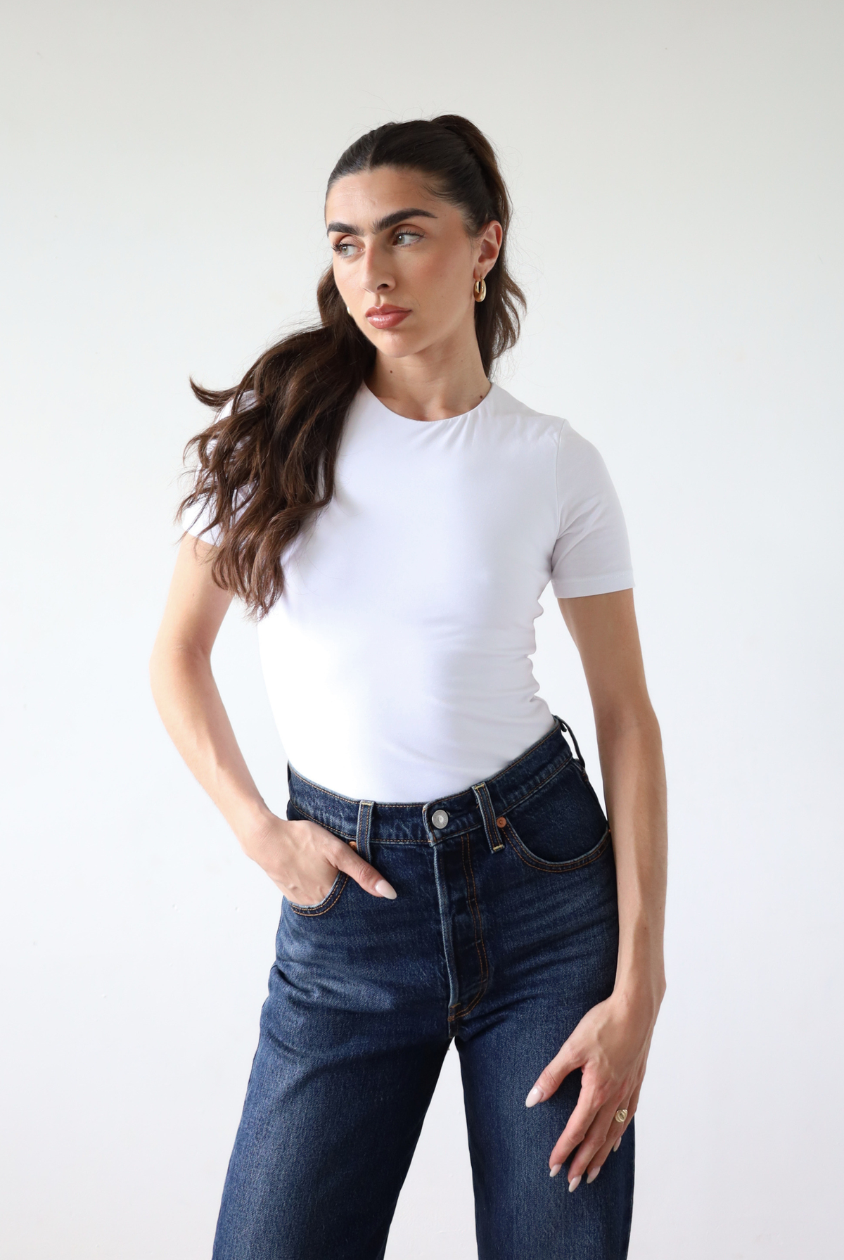 Organic cotton white crew neck short sleeve bodysuit on model, front
