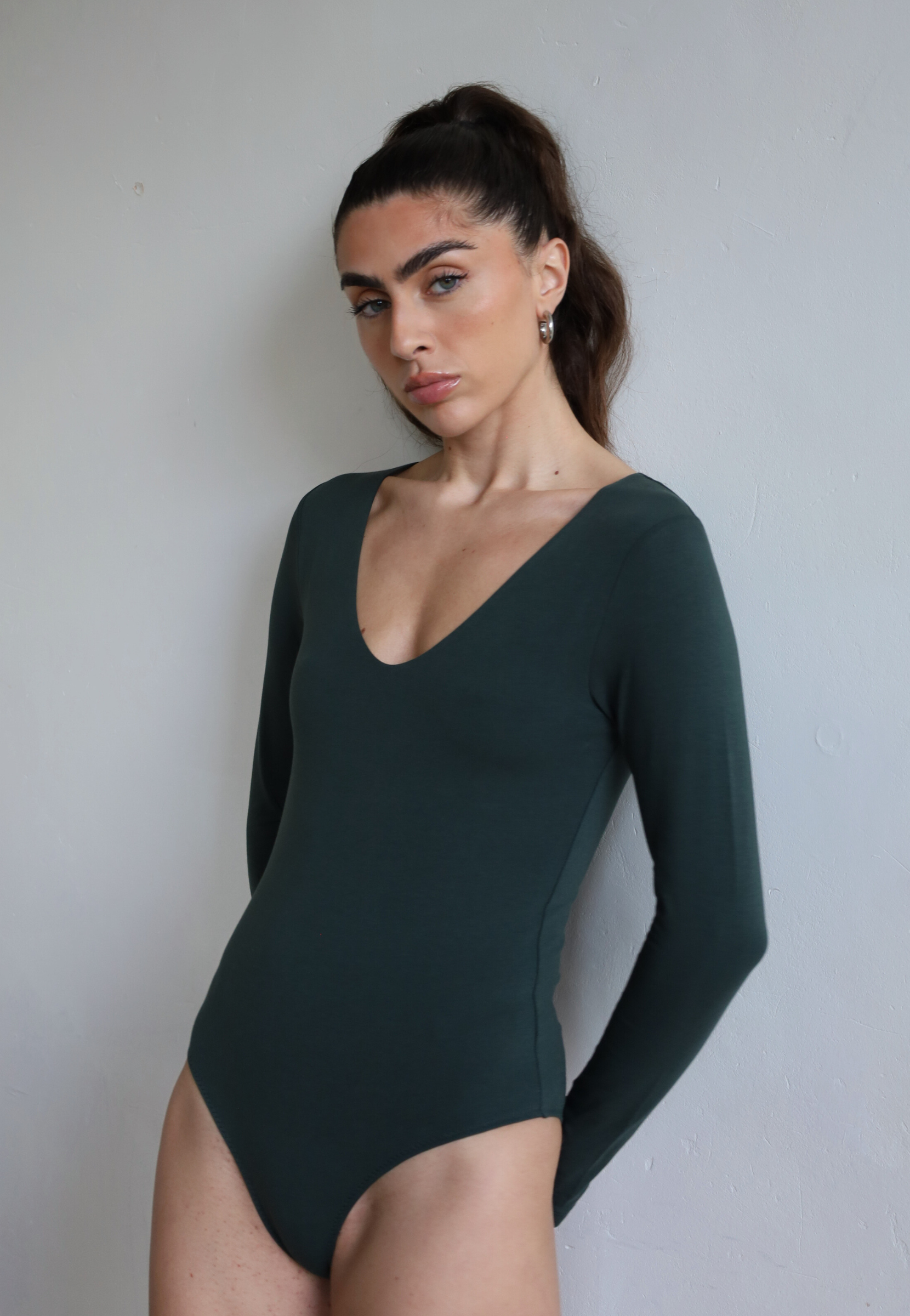 Green V-neck organic cotton bodysuit