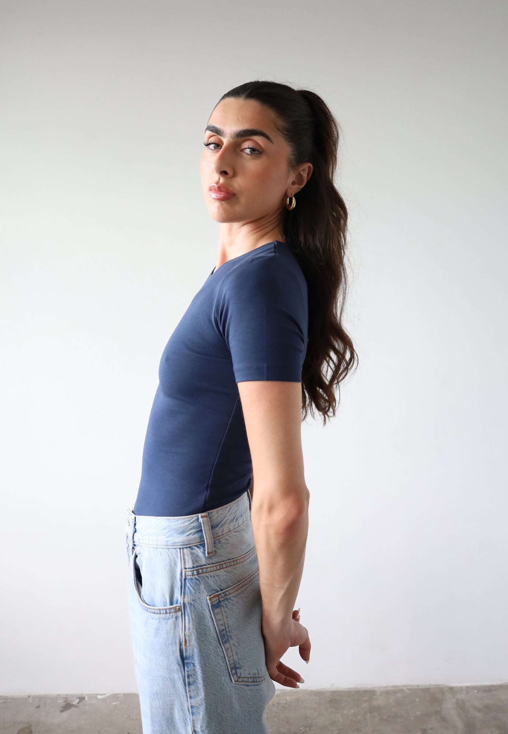 Organic cotton navy blue short sleeve t-shirt on model, side