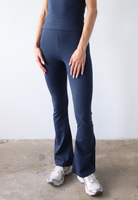 Organic cotton navy blue flared leggings on model, front