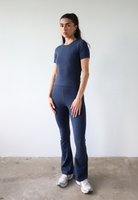 Organic cotton navy blue flared leggings on model, front