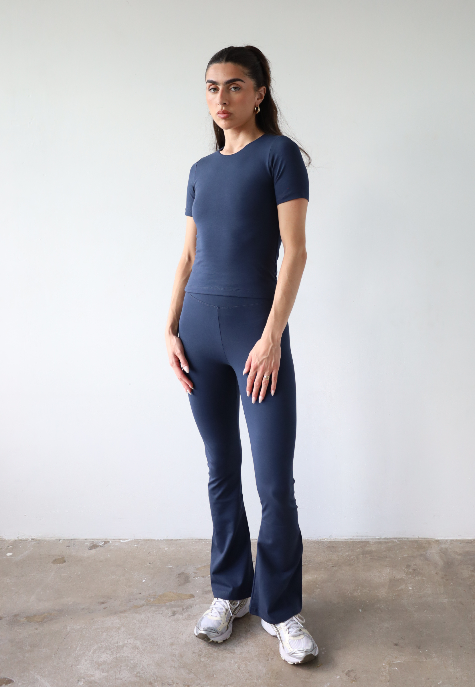 Organic cotton navy blue flared leggings on model, front