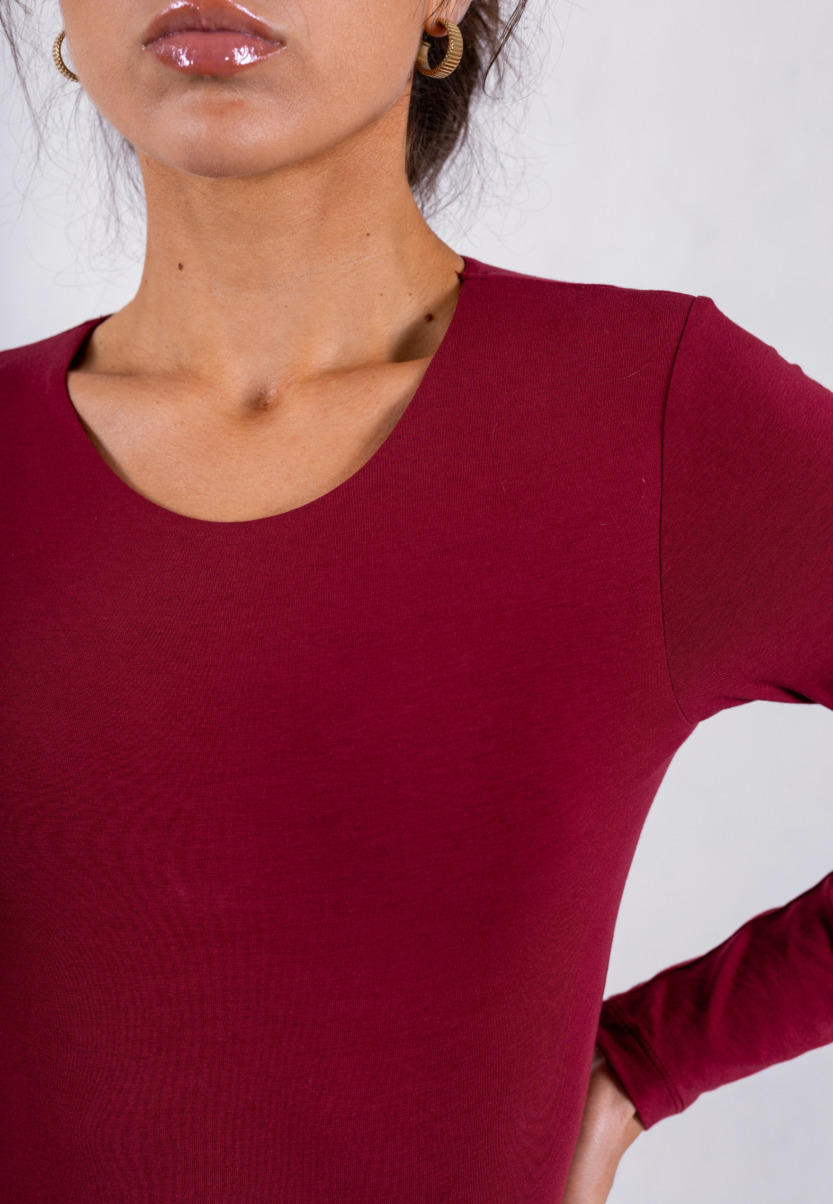 close up of red organic cotton long sleeve crew neck bodysuit