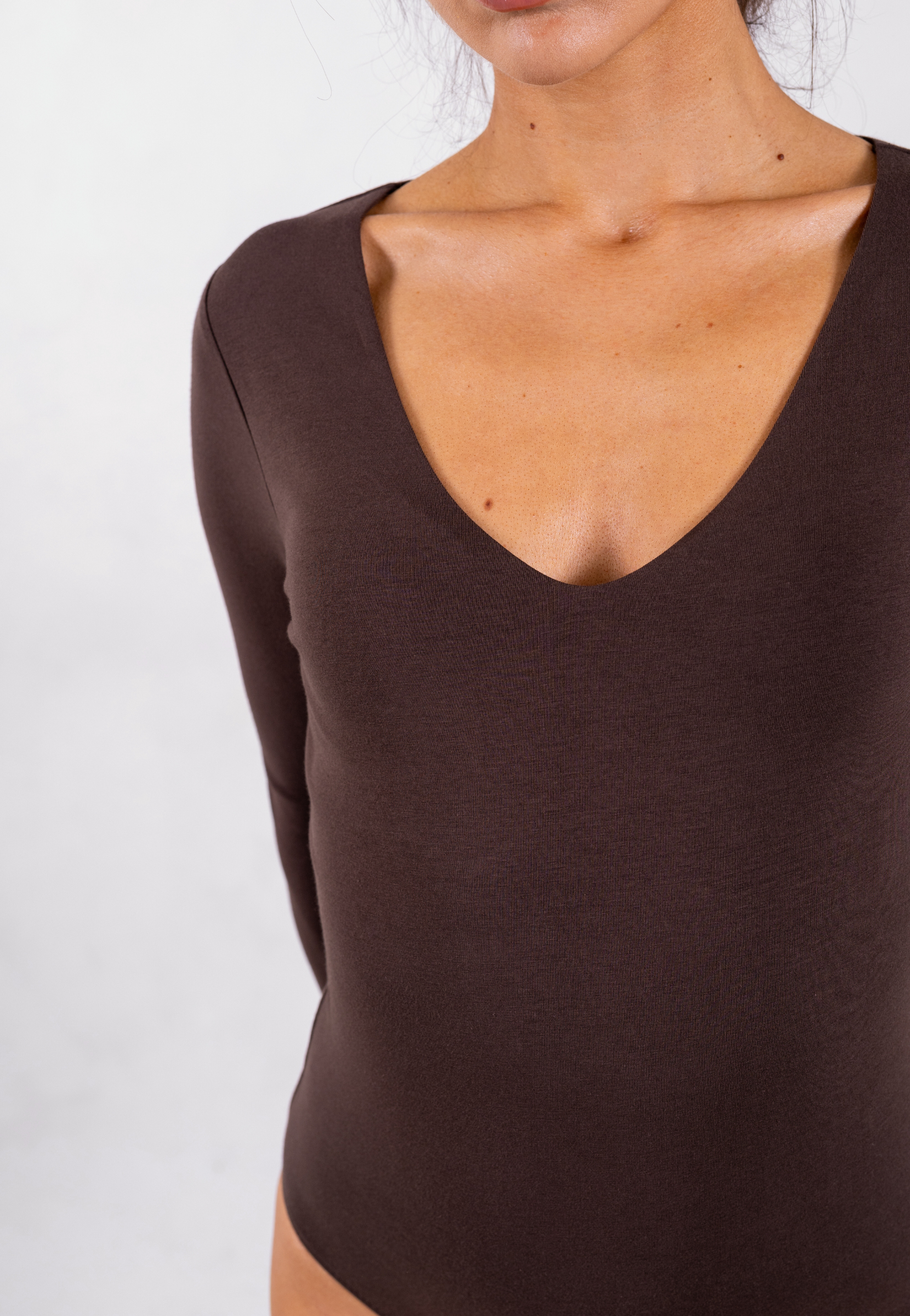 close up of brown organic cotton v-neck long sleeve bodysuit