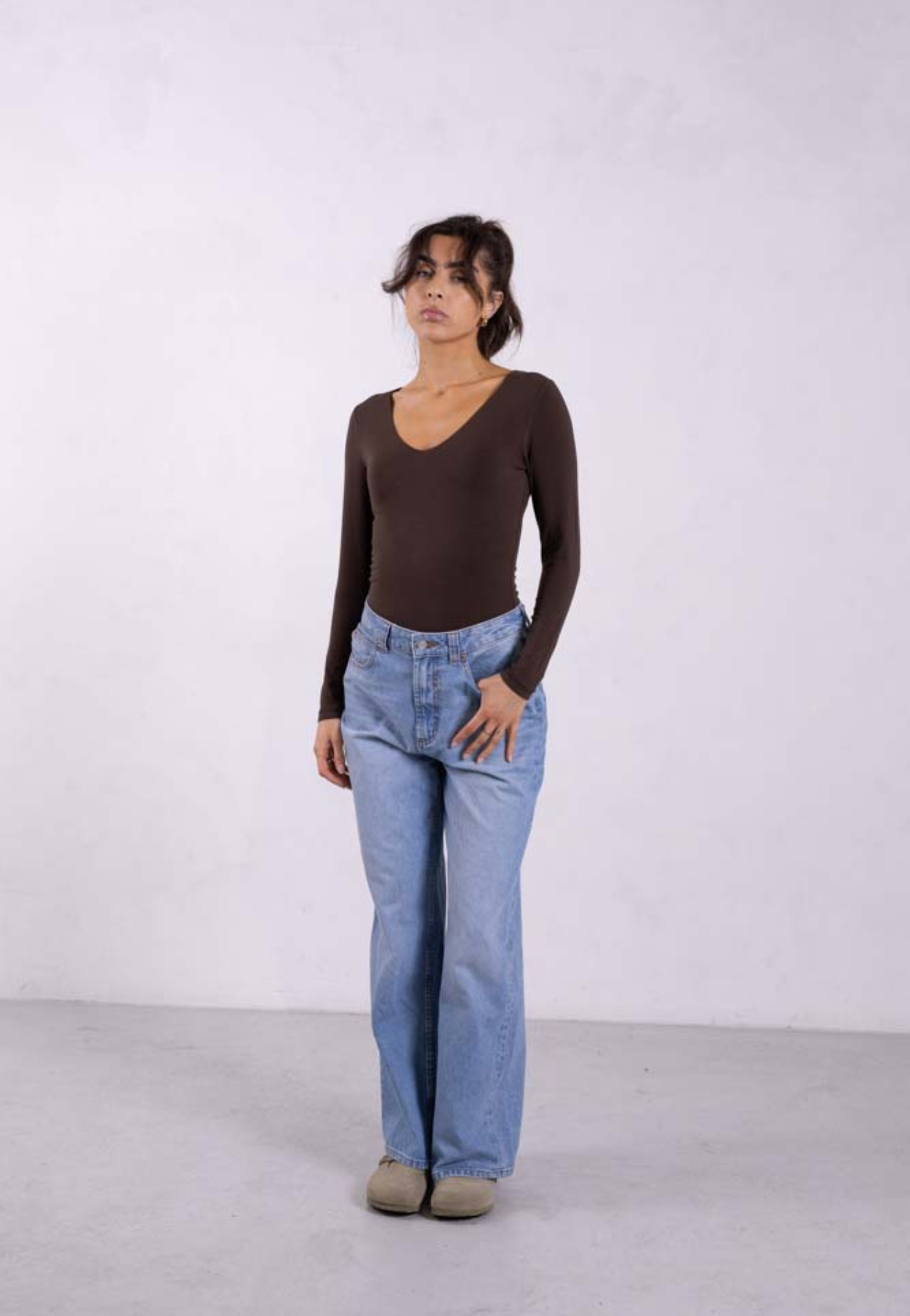 styled image of brown organic cotton v-neck long sleeve bodysuit
