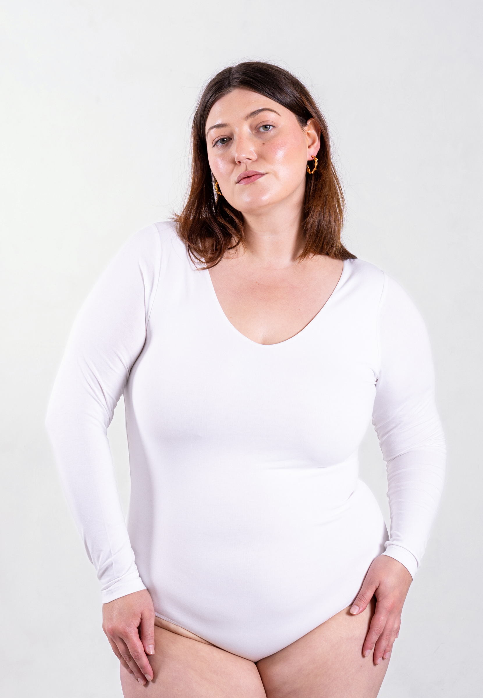 front of white organic cotton v-neck long sleeve bodysuit