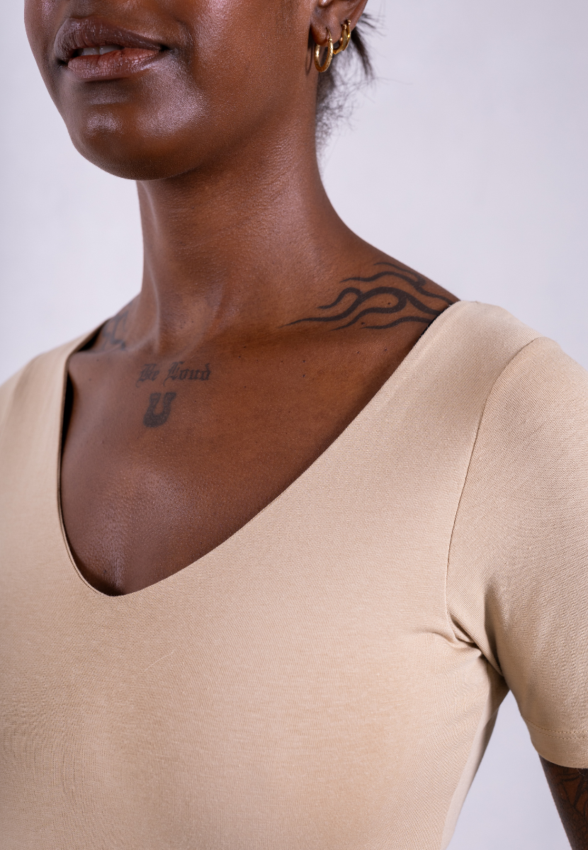 close up of organic cotton short sleeve v-neck oat bodysuit