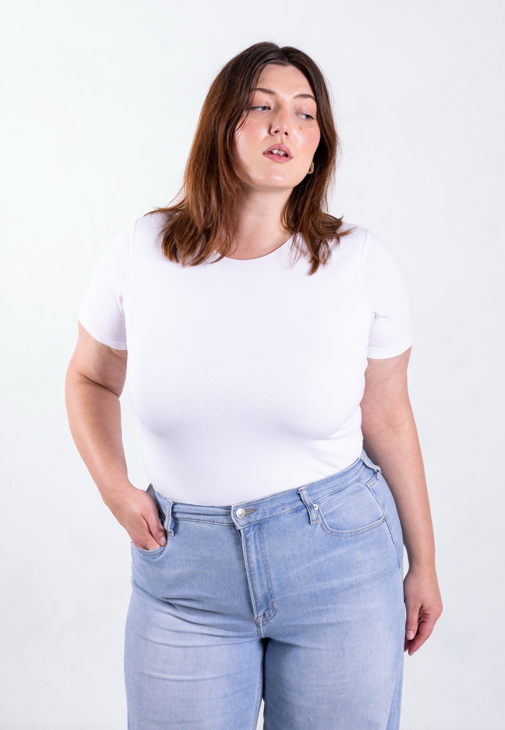 Front view of women's white organic cotton t-shirt in size 2XL on plus-size model, showing body hugging fit and full coverage
