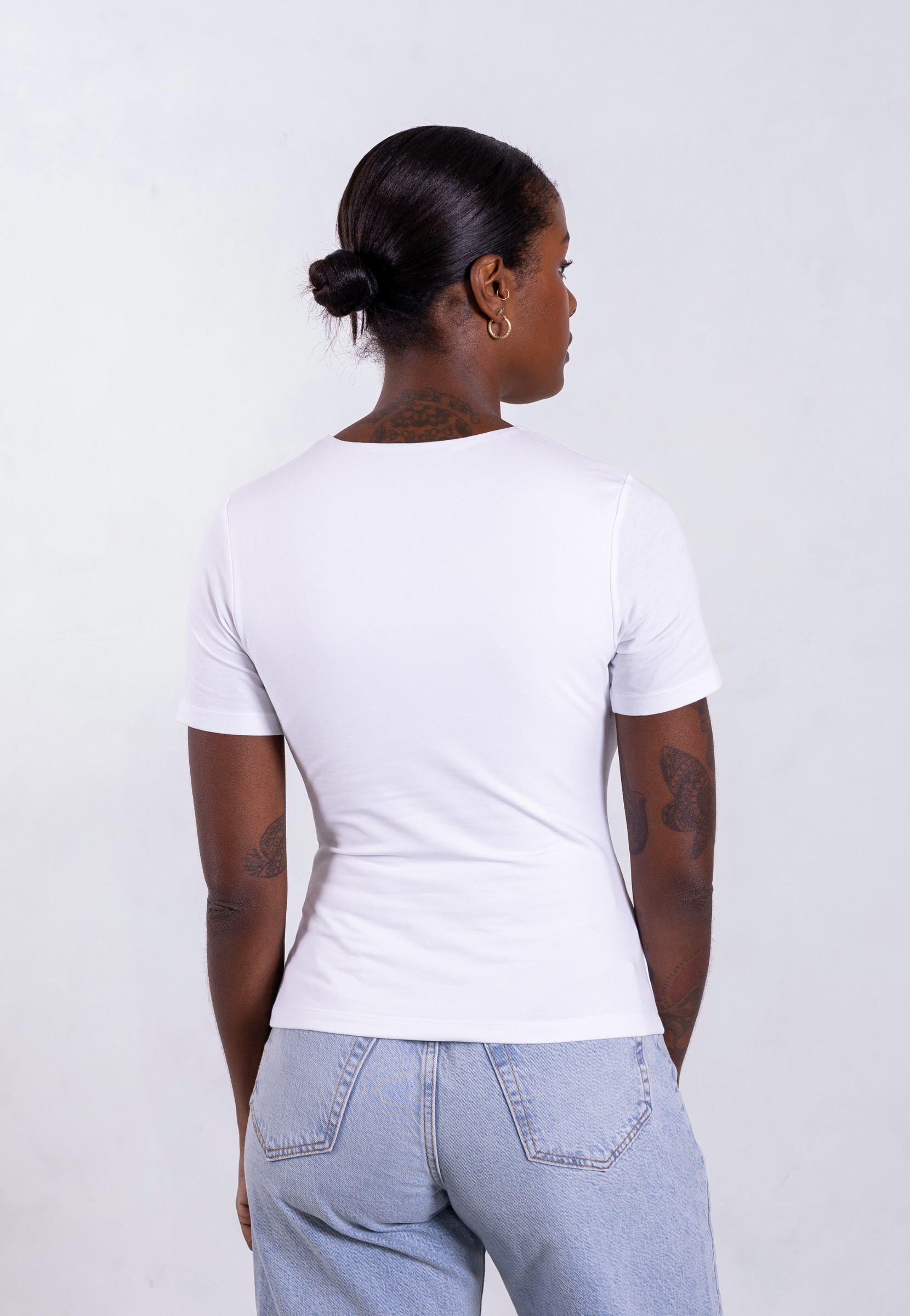Back view of women's white organic cotton short sleeve t-shirt showing clean design and relaxed fit